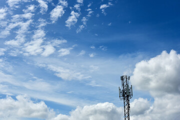 Obraz premium Telecommunication towers with clouds on blue sky background.