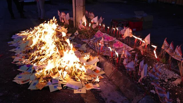 Chinese hungry ghost festival burning flame fire glowing ashes firefly colourful variety prayer paper joss money fake currency joss stick mini fag food fruit offering