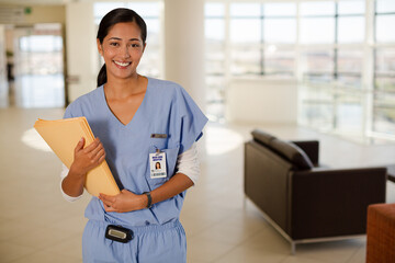 Portrait of smiling nurse in hospital corridor
