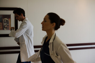 Doctors rushing down hospital corridor