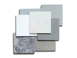 stack of white, grey, beige of artificial stone samples isolated on white background with clipping path. Set of different quartz surface material for furnishing in interior architecture works.