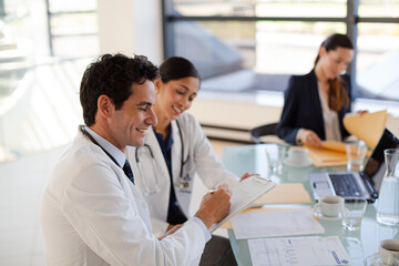 Doctors and businesswoman talking in meeting