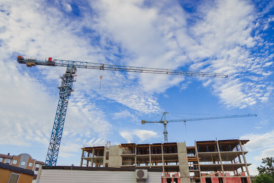 construction apartment building concrete bare frame shape and industrial crane outskirts photo foreshortening from below