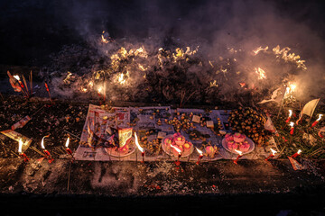 hinese hungry ghost festival burning flame fire glowing ashes firefly colourful variety prayer paper joss money fake currency joss stick mini fag food fruit offering