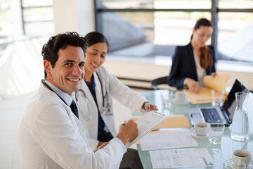Doctors and businesswoman talking in meeting