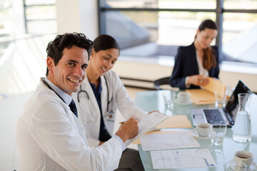 Doctors and businesswoman talking in meeting