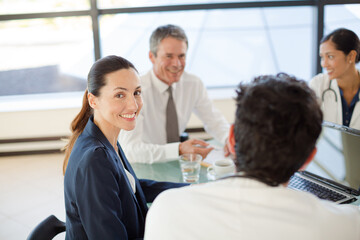 Doctors and businesswoman talking in meeting