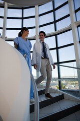 Doctor and nurse talking on staircase