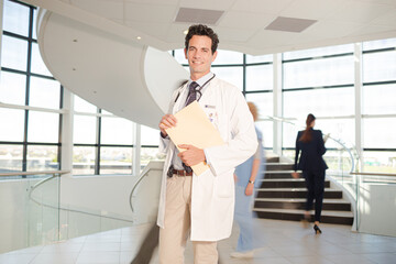 Portrait of smiling doctor in hospital atrium