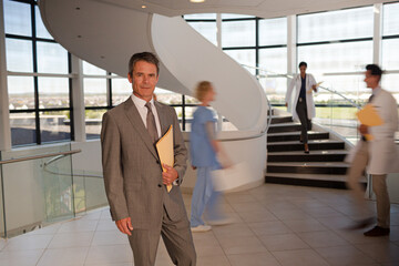 Portrait of smiling businessman in hospital