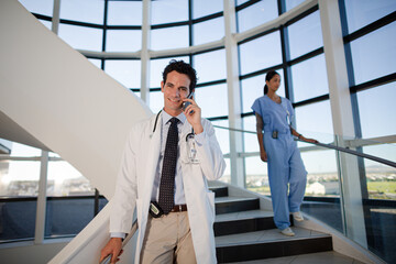 Doctor talking on cell phone in hospital