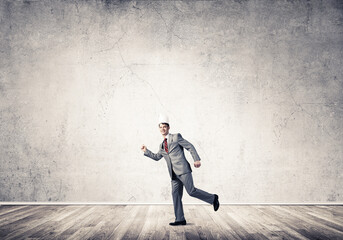 King businessman in elegant suit running in empty room