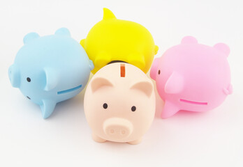Bankruptcy of savings funds concept. Many piggy banks laying and one standing.