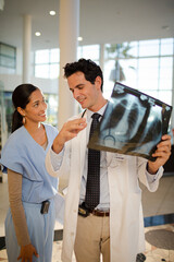 Doctor and nurse viewing chest x-rays