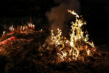 Chinese hungry ghost festival burning flame fire glowing ashes firefly colourful variety prayer...