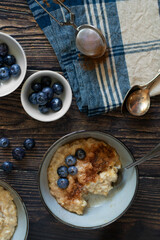 Oatmeal or porridge, for breakfast. Wooden background