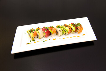 Rainbow Uramaki with Ripe Avocado, Marinated Salmon, Red Tuna, Chives and Butterfish with Spicy Soy Sauce