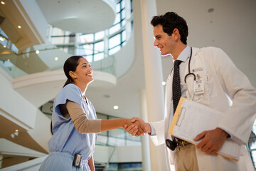 Fototapeta premium Doctor and nurse handshaking in hospital