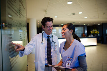 Doctor and nurse talking in hospital corridor