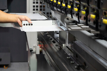 The technician operator working with hydraulic press brake bending machine.