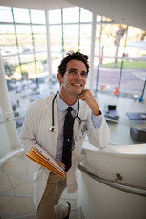Portrait of smiling doctor on stairs in hospital