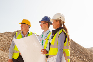 Business people and workers talking in quarry