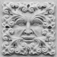 A stone carving of a Green Man. Decorative architectural ornament.
