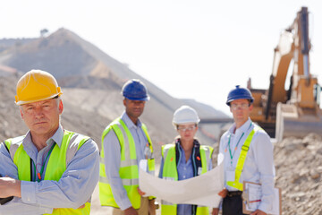 Business people and workers talking in quarry