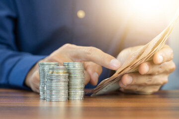Hand counting money and coins stack business investment