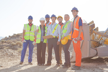 Business people and workers talking in quarry