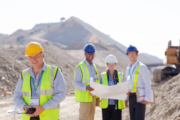 Business people and workers talking in quarry