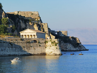 Fototapeta na wymiar corflu island castle, liight and church of st george by the sea , greece