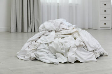 Fototapeta na wymiar Pile of dirty laundry on floor indoors