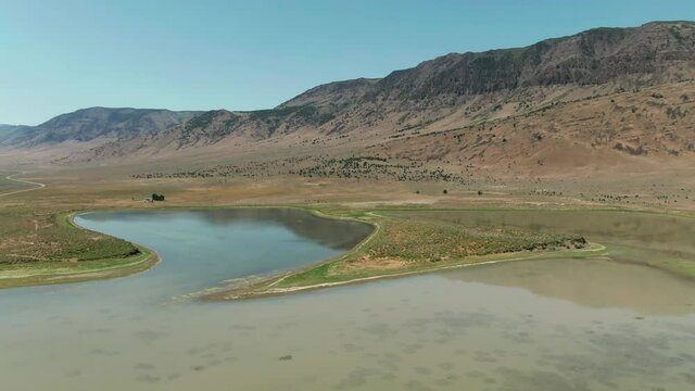 Aerial: Juniper Lake, A Reflective Lake In The Dessert, Steens Mountain Wilderness, Oregon, USA