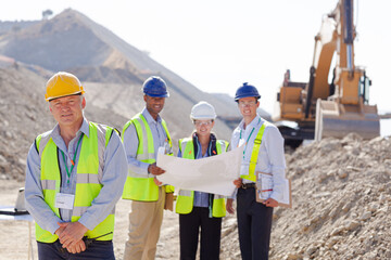 Business people and workers talking in quarry
