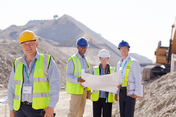 Business people and workers talking in quarry