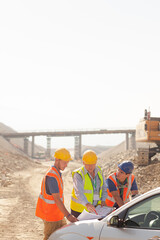 Worker using walkie-talkie in quarry