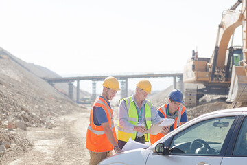 Worker using walkie-talkie in quarry