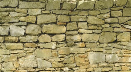 Old sandstone wall closeup for background, old castle wall, stone texture.