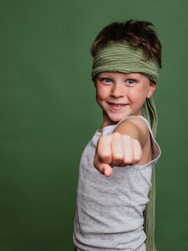 Playful Karate Child Reaching Out Fist Towards Camera