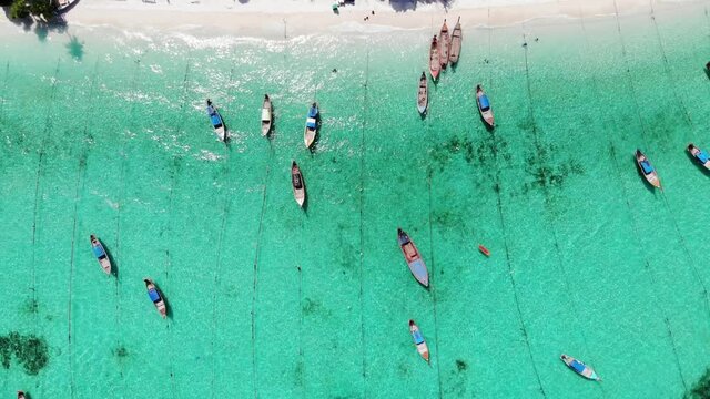 Wooden long-tail boats on coastline in tropical sea at lipe island
