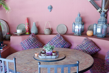 Table and chairs against purple wall