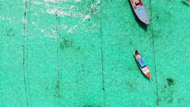 Wooden long-tail boats on coastline in tropical sea at lipe island