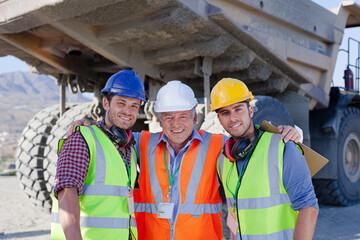 Businessmen in hard hats standing on site