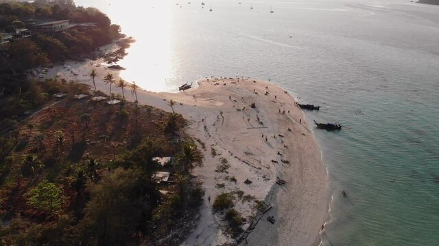 Emerald tropical sea with white sand beach in the sunset at lipe island