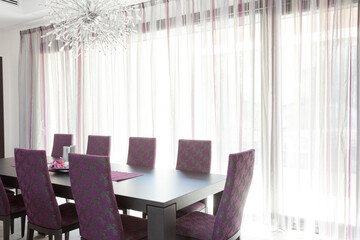 Chandelier over dining table in luxury dining room
