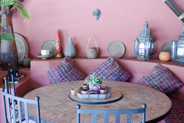 Table and chairs against purple wall