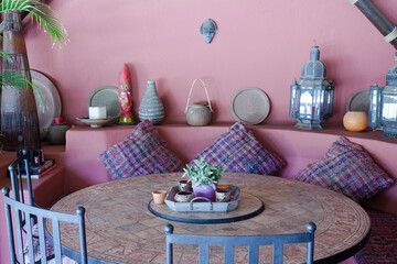 Table and chairs against purple wall