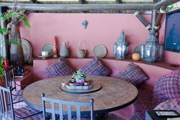 Table and chairs against purple wall