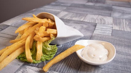 fried potatoes on the table and sauce